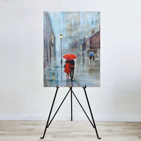 Red in the rain couple with an umbrella