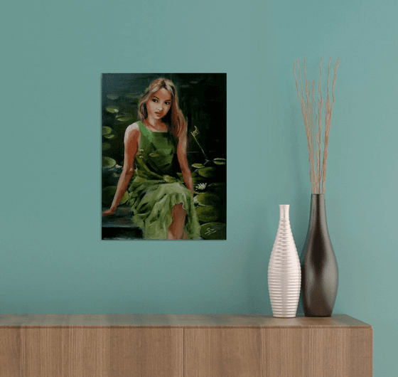 Girl sitting  by the pond