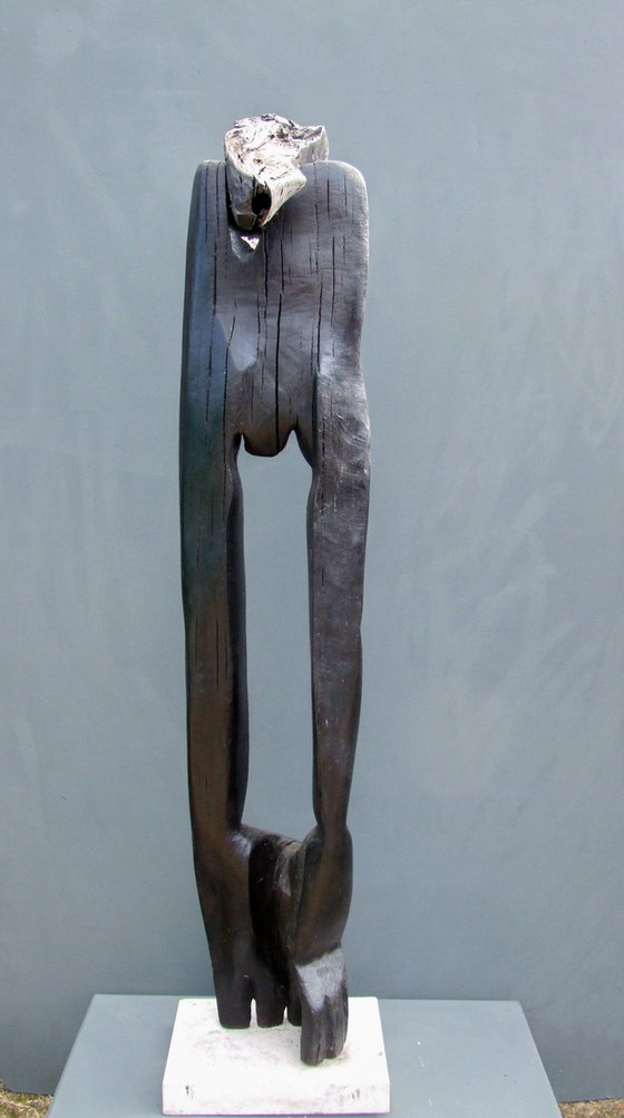 "The Flower Picker" (walking through a landmine field) Bog Oak wood carving, from the series ----- Fossilized Wood