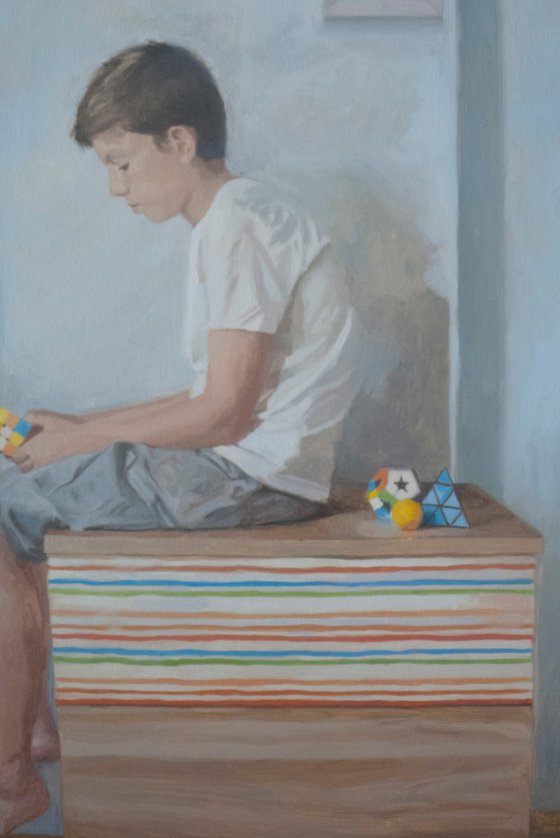 Boy playing Rubik cube