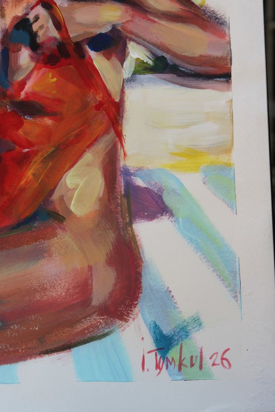 Girl in a red orange swimsuit and panama hat