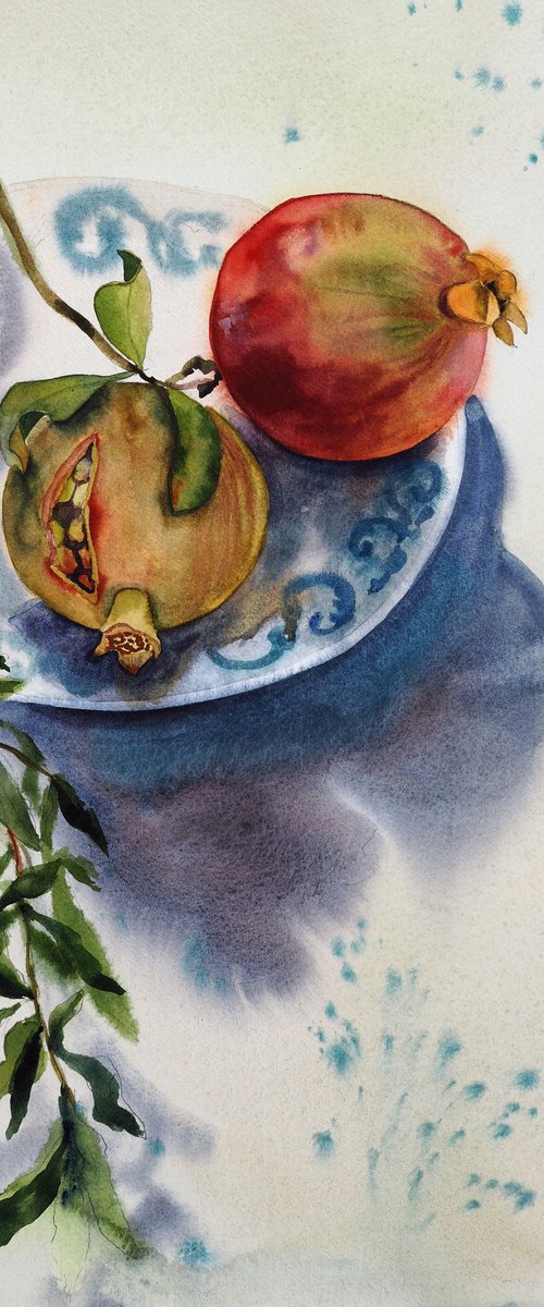 Pomegranates on a plate by Delnara El