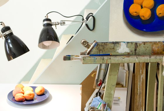 modern still life of apricots on a blue plate