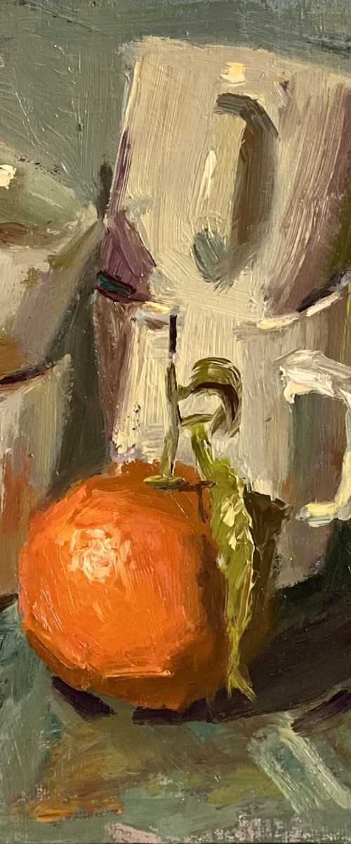 Stacked cups and oranges by Nithya Swaminathan