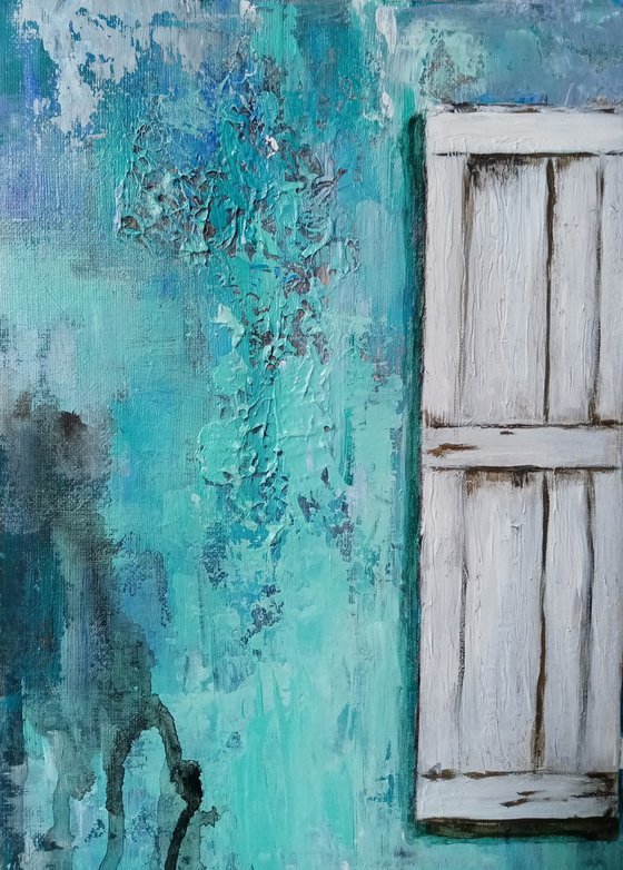 A window in a turquoise wall