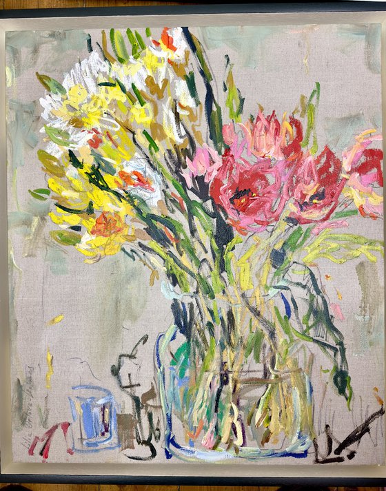 Tulips and daffodils in a glass vase