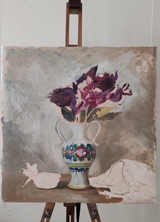 Purple flowers in a colorful jug