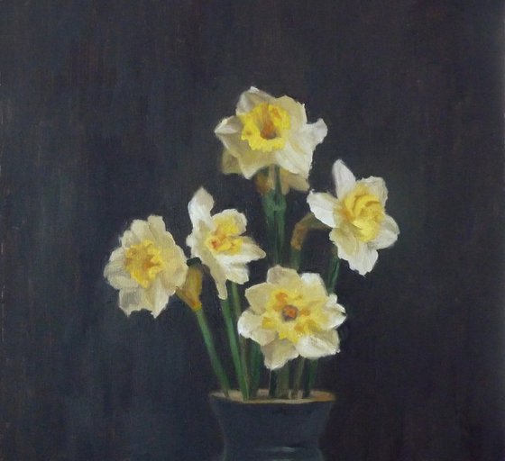 Five daffodils in a dark vase