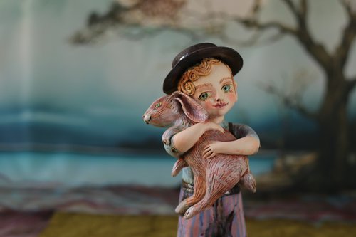 Vintage dressed boy holding a rabbit. by Elya Yalonetski