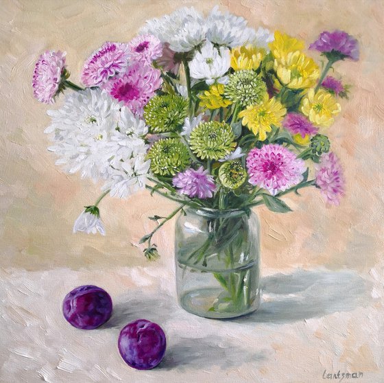 Asters  flower bouquet in a glass jar with pulms aside still life
