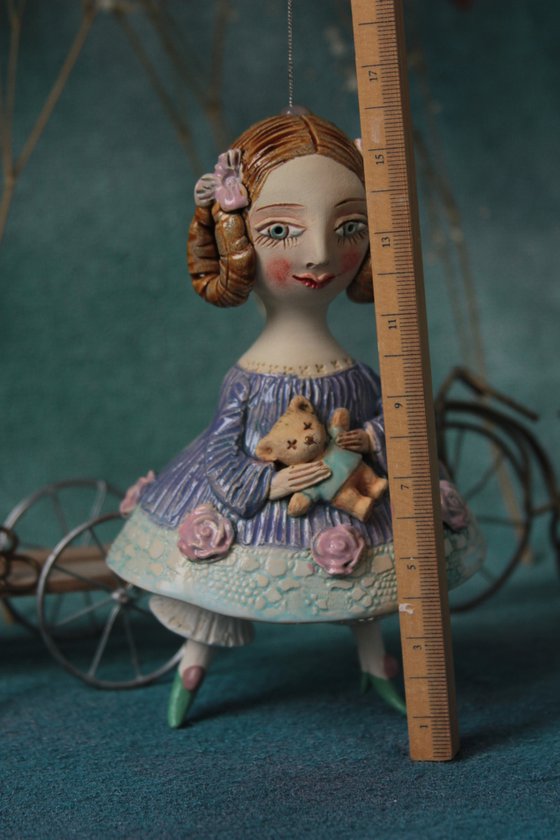 Little Girl in an blue dress with a teddy. Hanging sculpture, bell doll by Elya Yalonetski