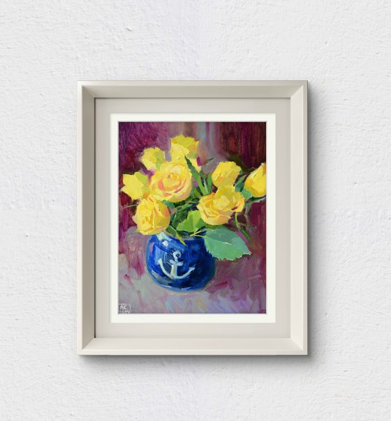 Yellow tulips in a blue vase