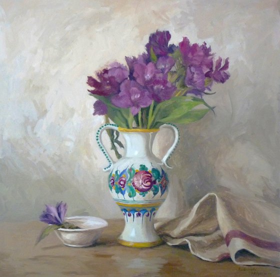 Purple flowers in a colorful jug