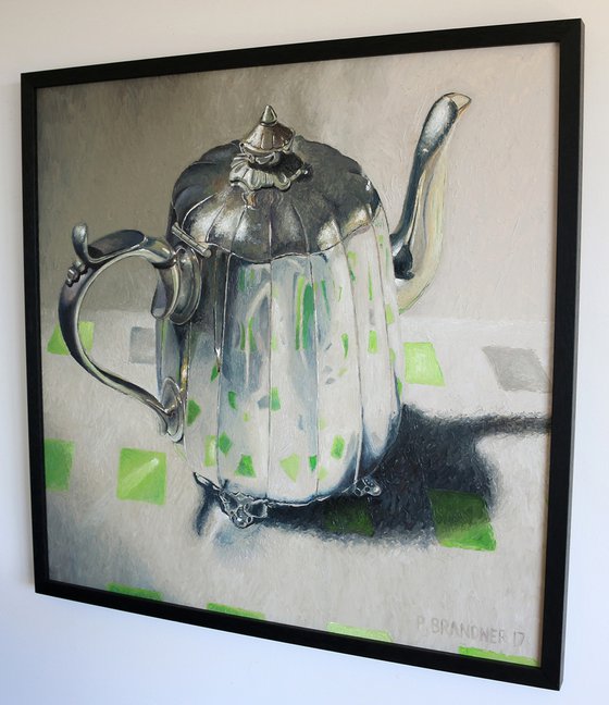 Teapot on green square cloth