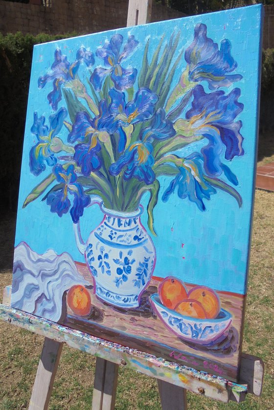 Vase of Irises with oranges.