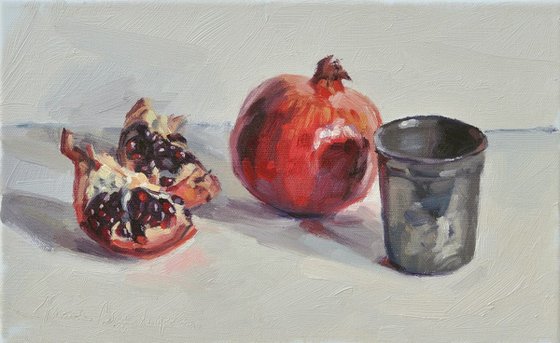 Pomegranates and tin cup