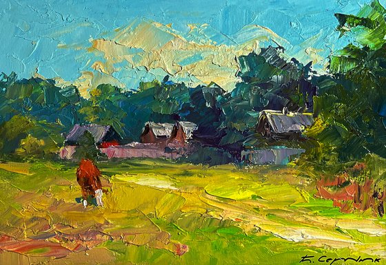 A Red Cow near the Houses