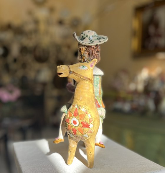 Vintage dressed girl with ice riding horse.