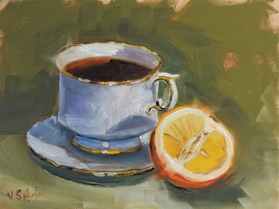 Teacup and orange. still life