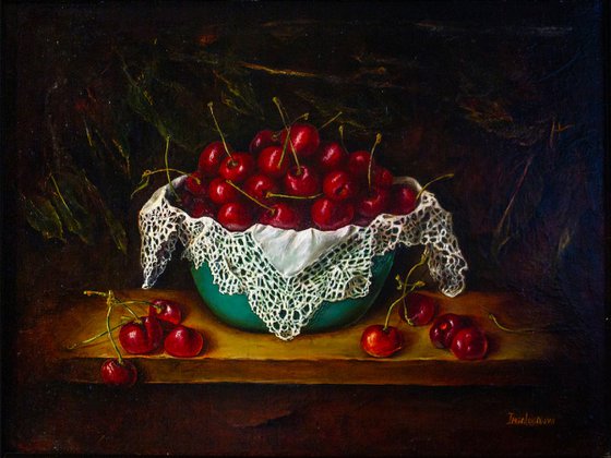Cherries in a turquoise bowl.