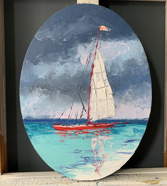 Red sail boat.