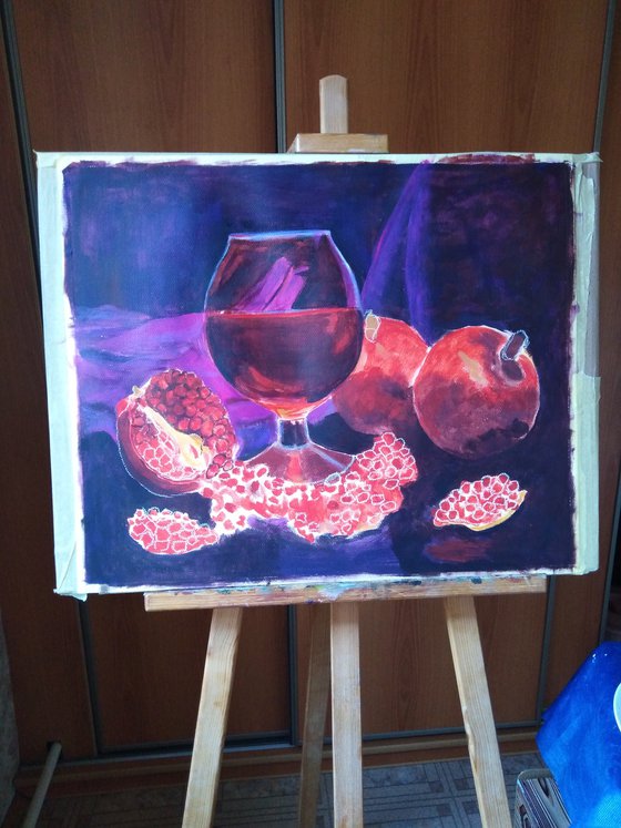 Ripe pomegranate and a glass of wine