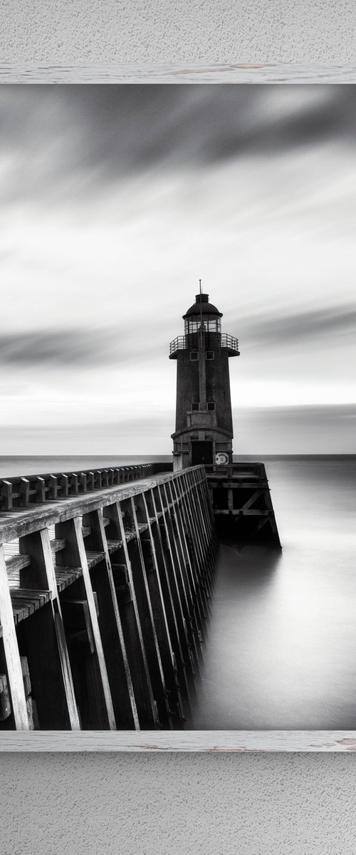 A lighthouse at the port by Karim Carella