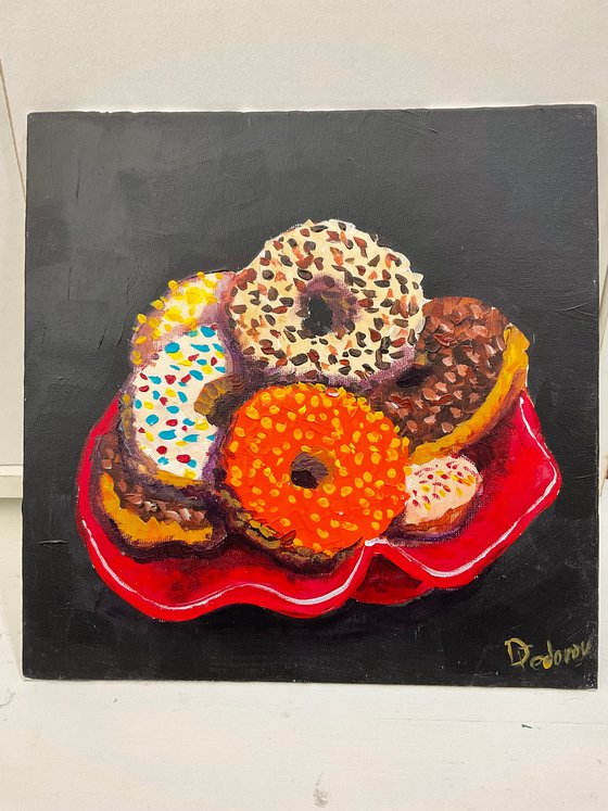 Colourful donuts in red dish