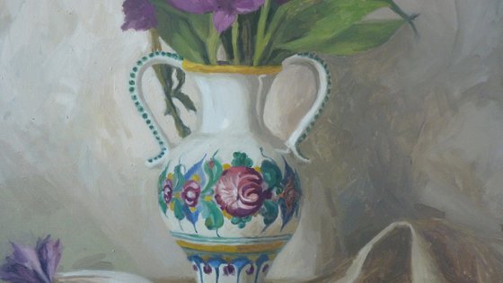Purple flowers in a colorful jug