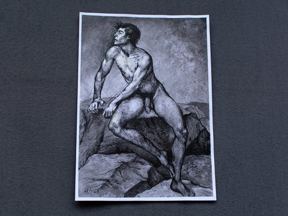 Nude young man sitting on a rock