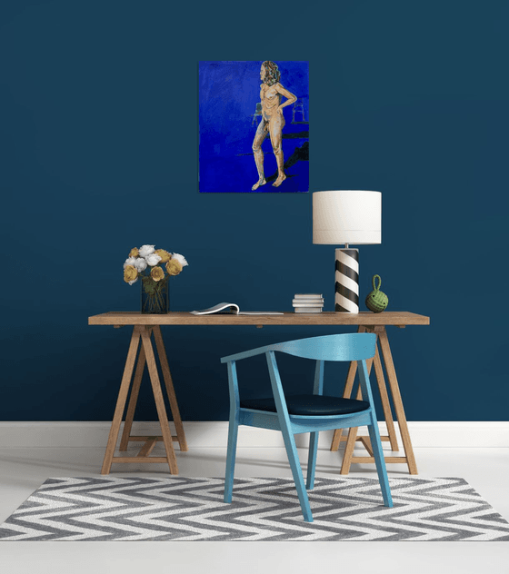 Young nude man in blue room