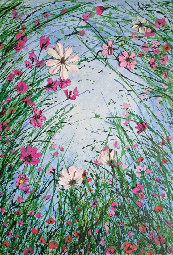 Relaxing in a summer meadow. Relief landscape with a green grass and pink textured wildflowers