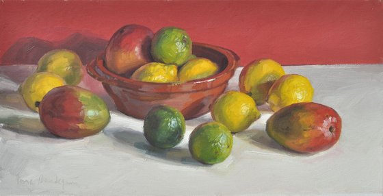 Mangos, lemons and limes, red background