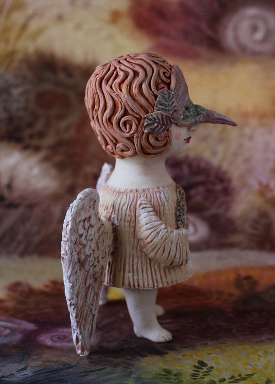 Angel holding a mask. Ceramic OOAK sculpture.