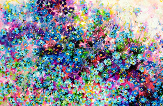 Forget me not flower field at sunrise