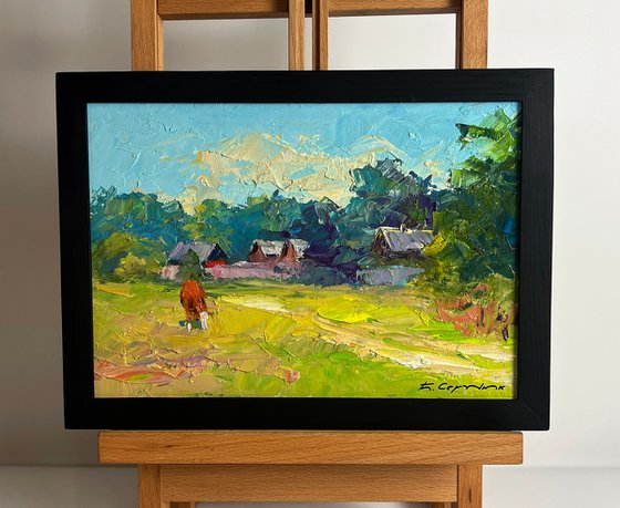 A Red Cow near the Houses