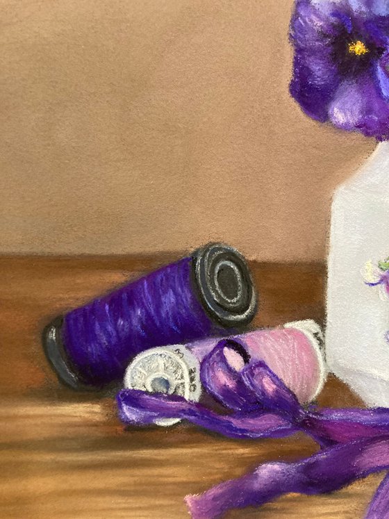 Violets, ribbon and cotton reels