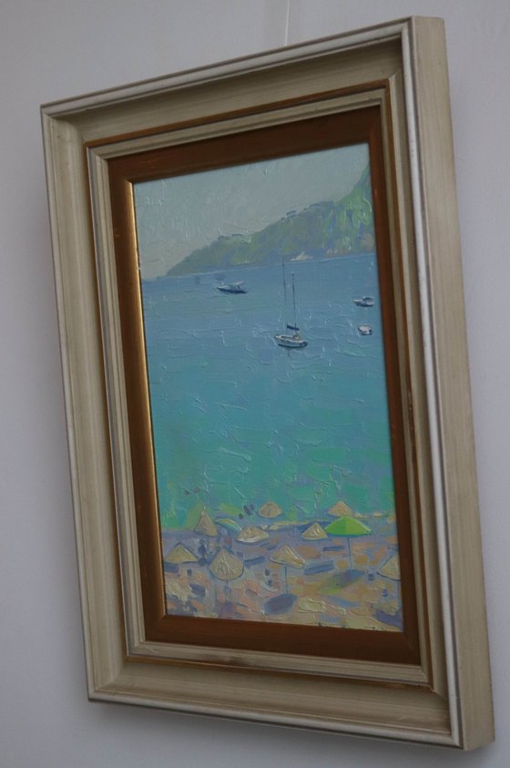 Yachts and umbrellas on the beach