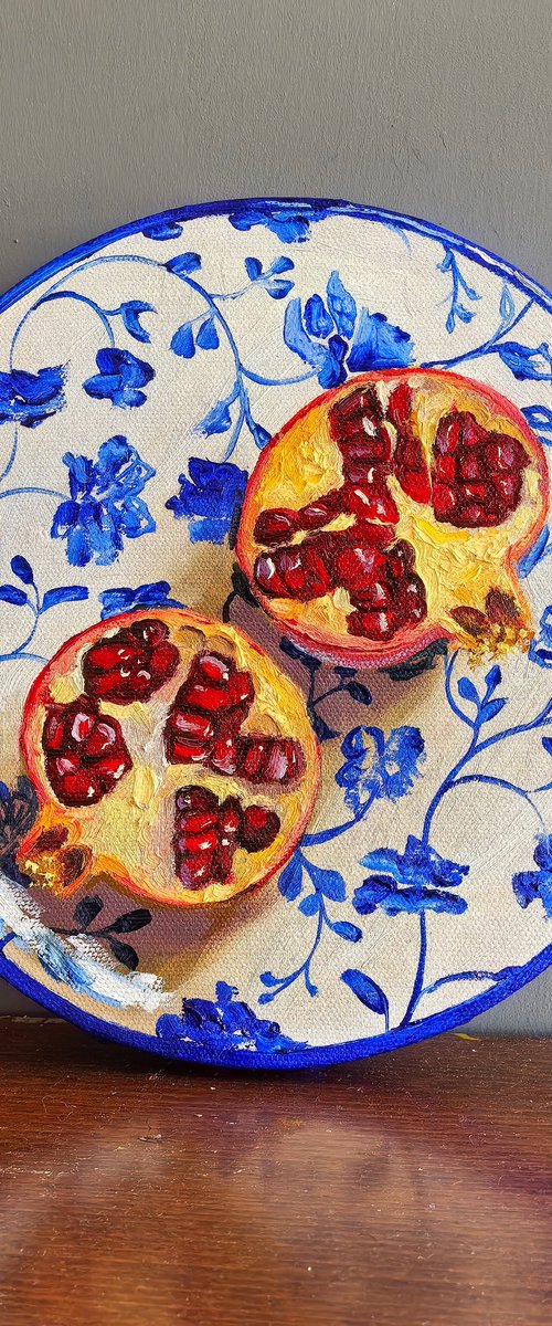 Pomegranate on plate by Leyla Demir