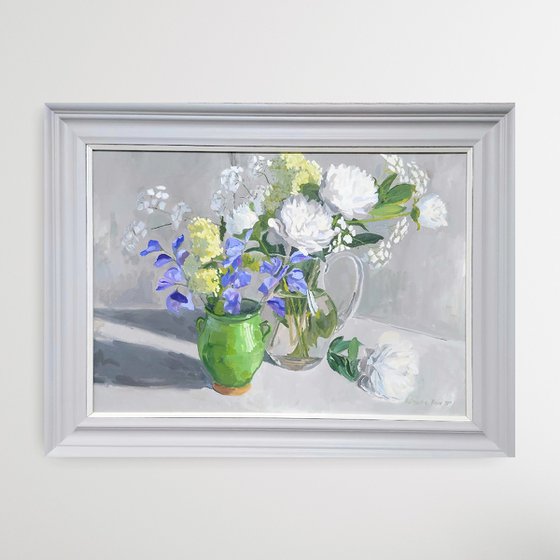White peonies and blue sweet peas in three vases