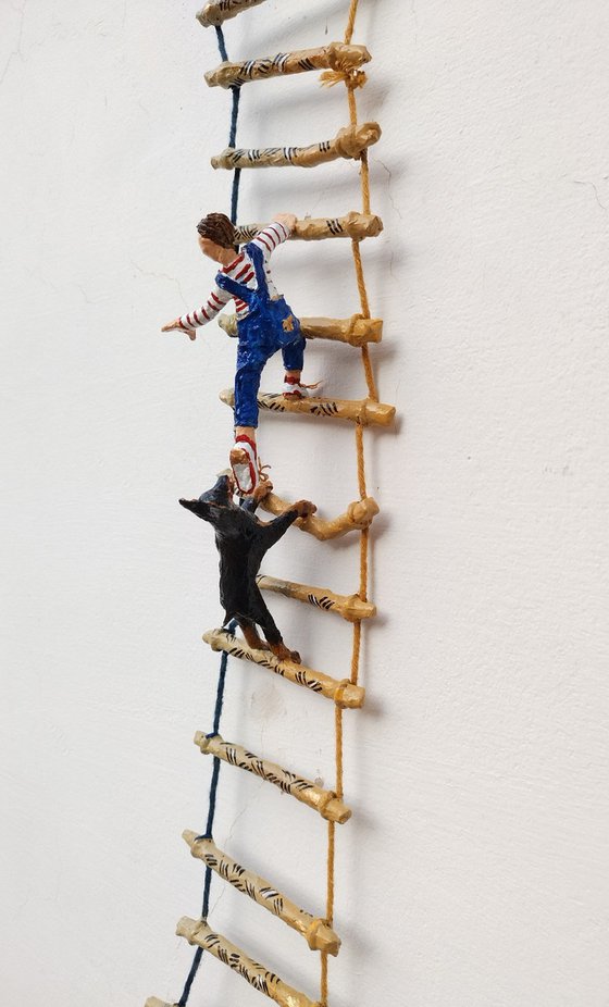 Two Dobermans and the figure on the ladder