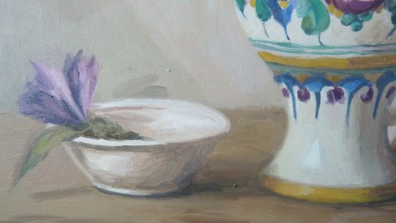 Purple flowers in a colorful jug