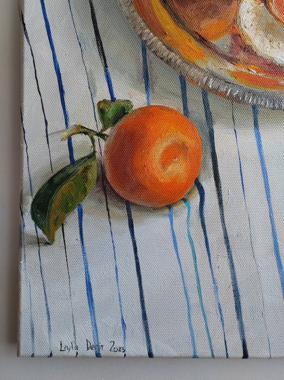 Clementines on stripen tablecloth