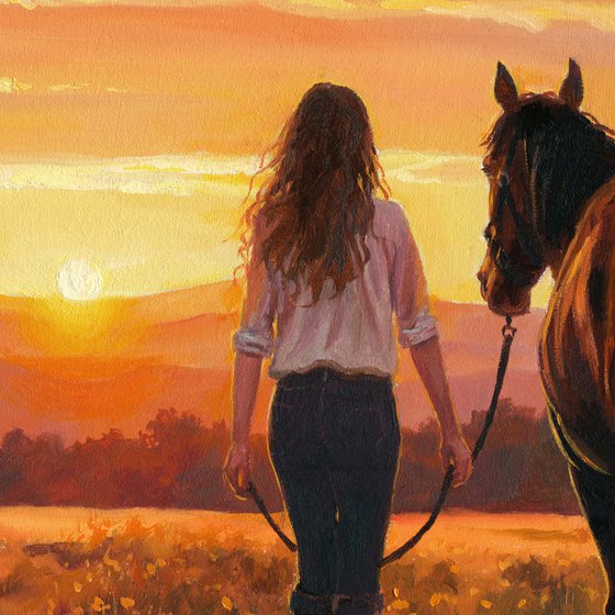 Woman walking with a horse in a sunset field