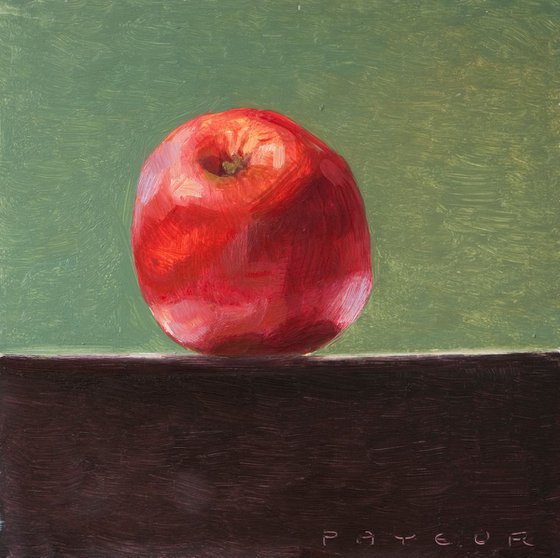 still life of fresh red apple on a green background