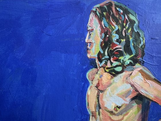 Young nude man in blue room