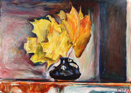 Black vase with autumn leaves