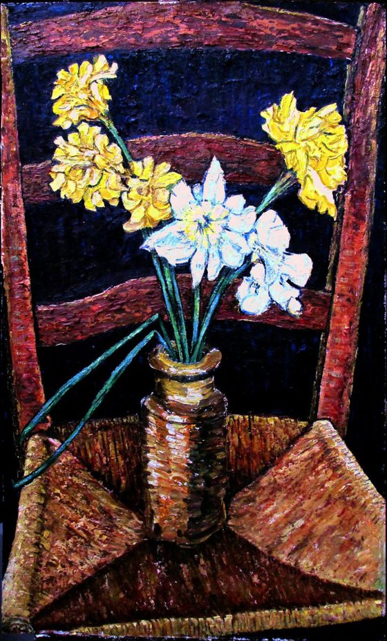 Daffodils in a stone pot on an old chair