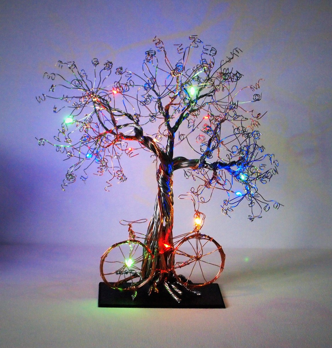 Silver and Copper wire tree sculpture with Bicycle and multi-coloured LED lights by Steph Morgan
