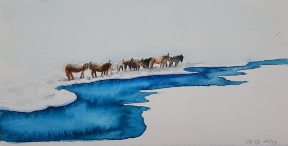 Horses near the river in winter